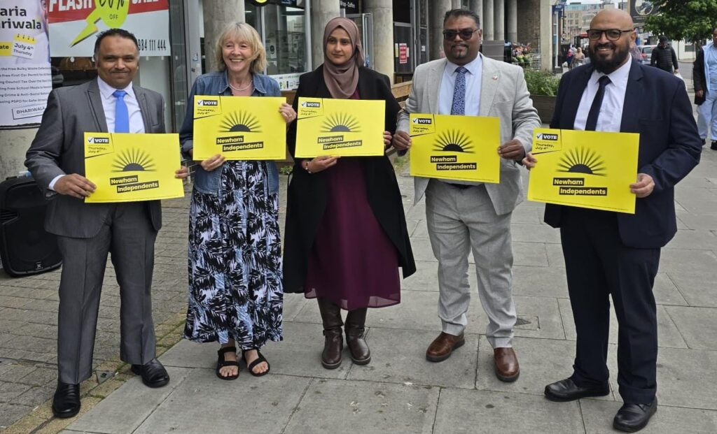 Two women and three men holding a placard saying Newham Independents.