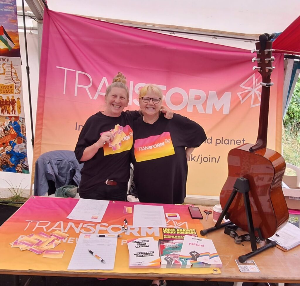 Two women standing at a Transform stall